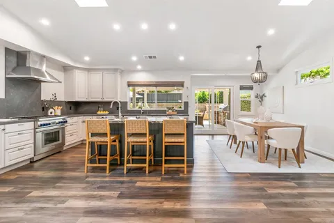 a large kitchen with a table and chairs
