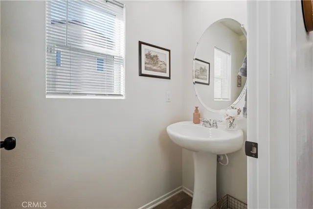 a bathroom with a sink a mirror and a window