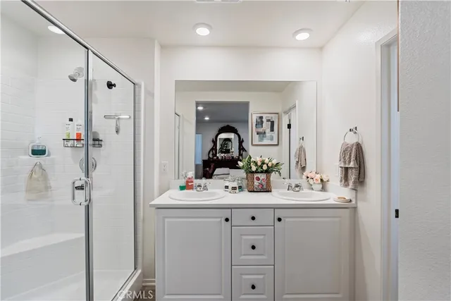 a bathroom with a sink vanity and mirror