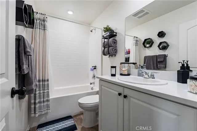 a bathroom with a sink a toilet and a shower