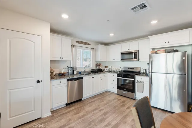 a kitchen with a refrigerator a stove top oven a sink and dishwasher
