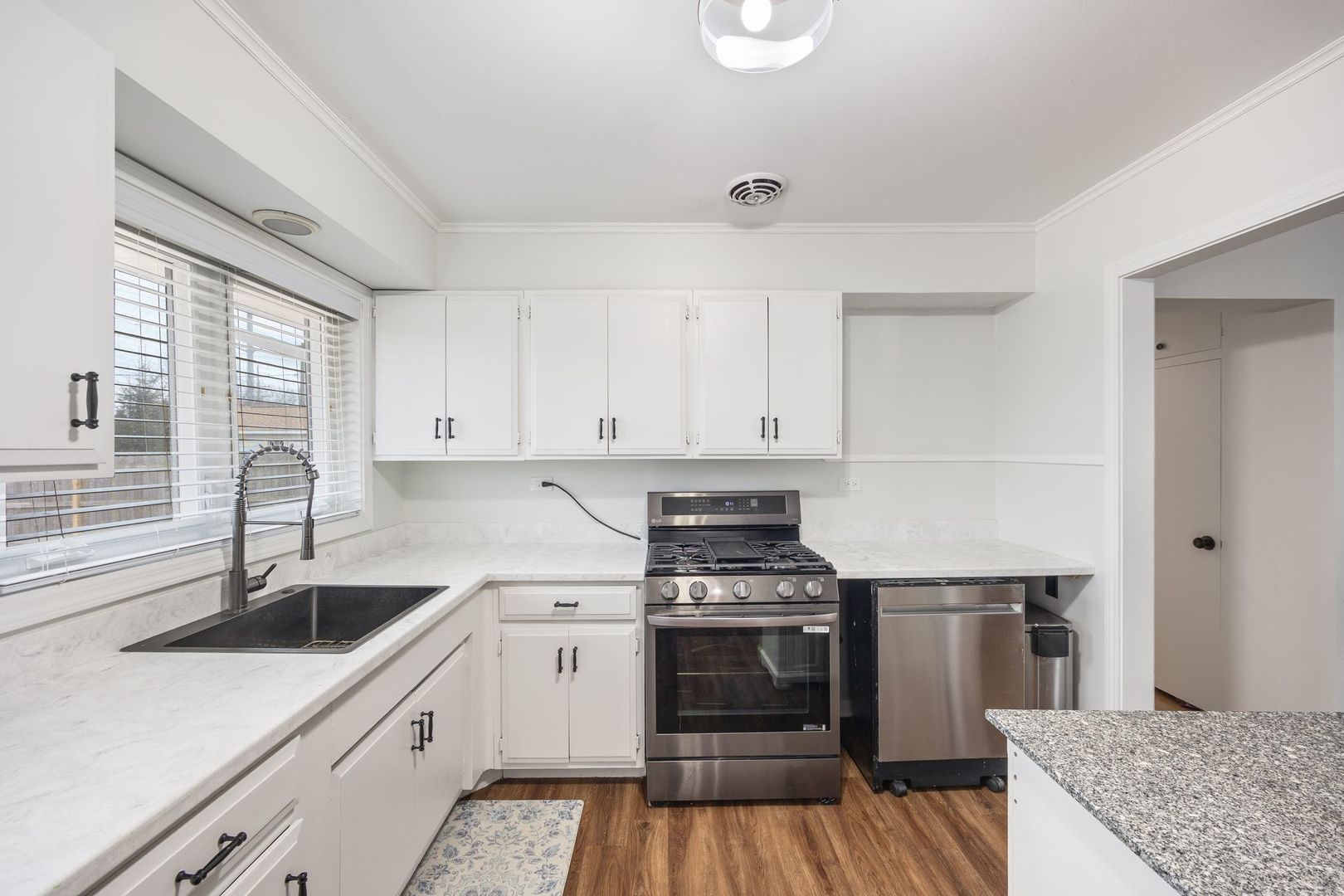 1145 Dell Road Northbrook, IL 60062 - Photo 10 of 22 a kitchen with granite countertop a sink stainless steel appliances and cabinets