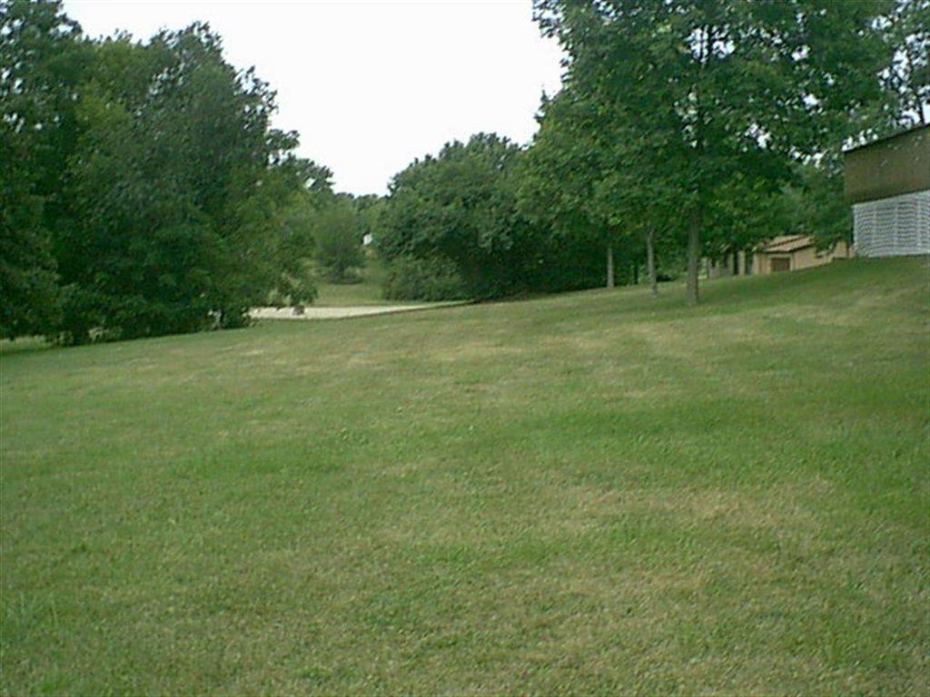 1025 Lake Summerset Road Lake Summerset, IL 61019 - Photo 1 of 15 a view of a field with trees in the background