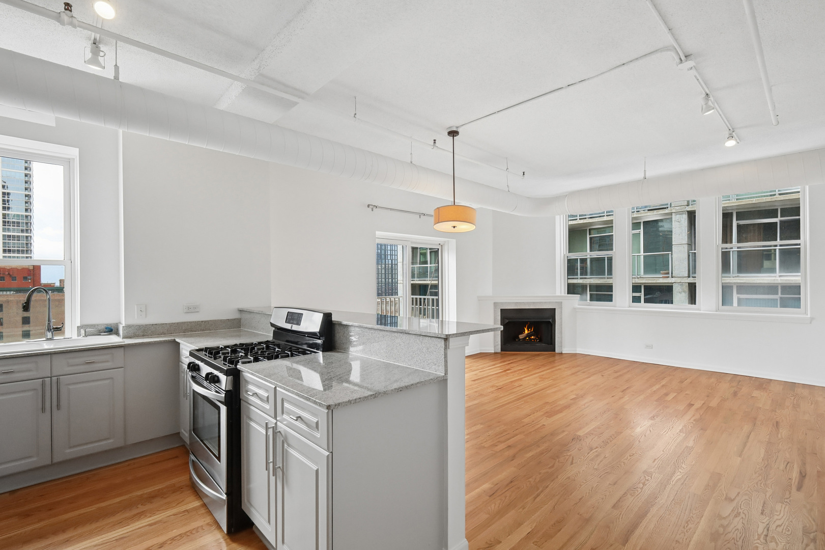 161 West Harrison Street, Unit 1007 Chicago, IL 60605 - Photo 12 of 35 a kitchen that has a sink a stove and cabinets