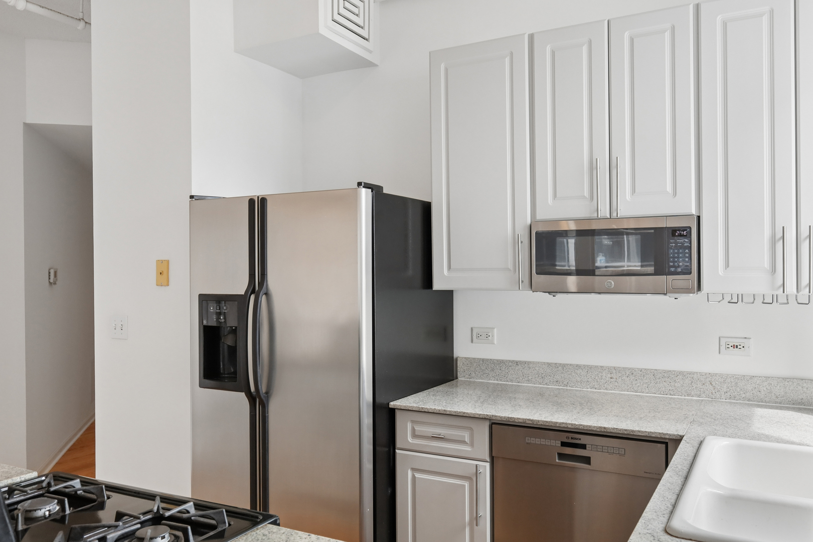 161 West Harrison Street, Unit 1007 Chicago, IL 60605 - Photo 13 of 35 a kitchen with stainless steel appliances a refrigerator and a stove top oven