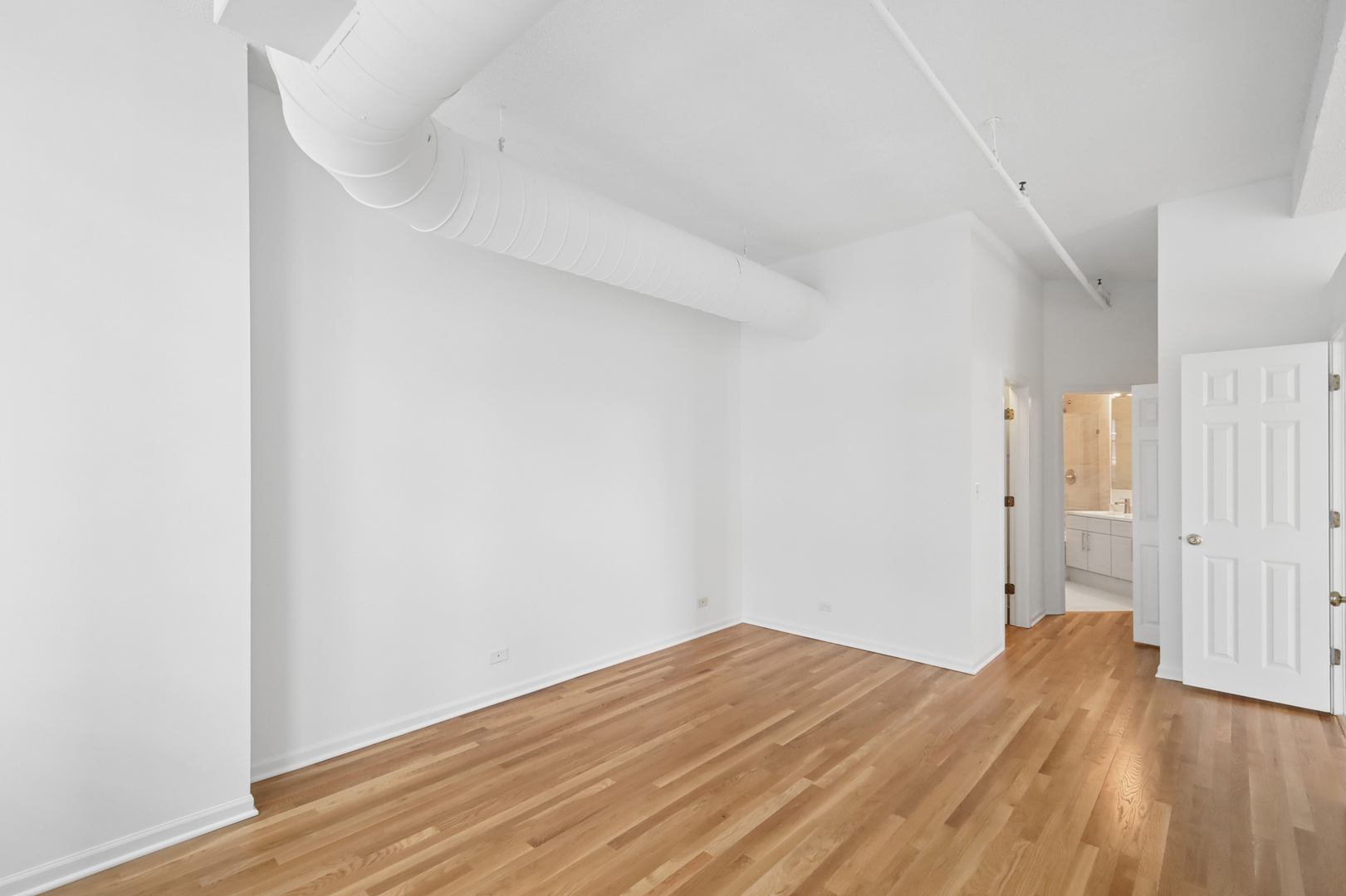 161 West Harrison Street, Unit 1007 Chicago, IL 60605 - Photo 17 of 35 a view of empty room with wooden floor