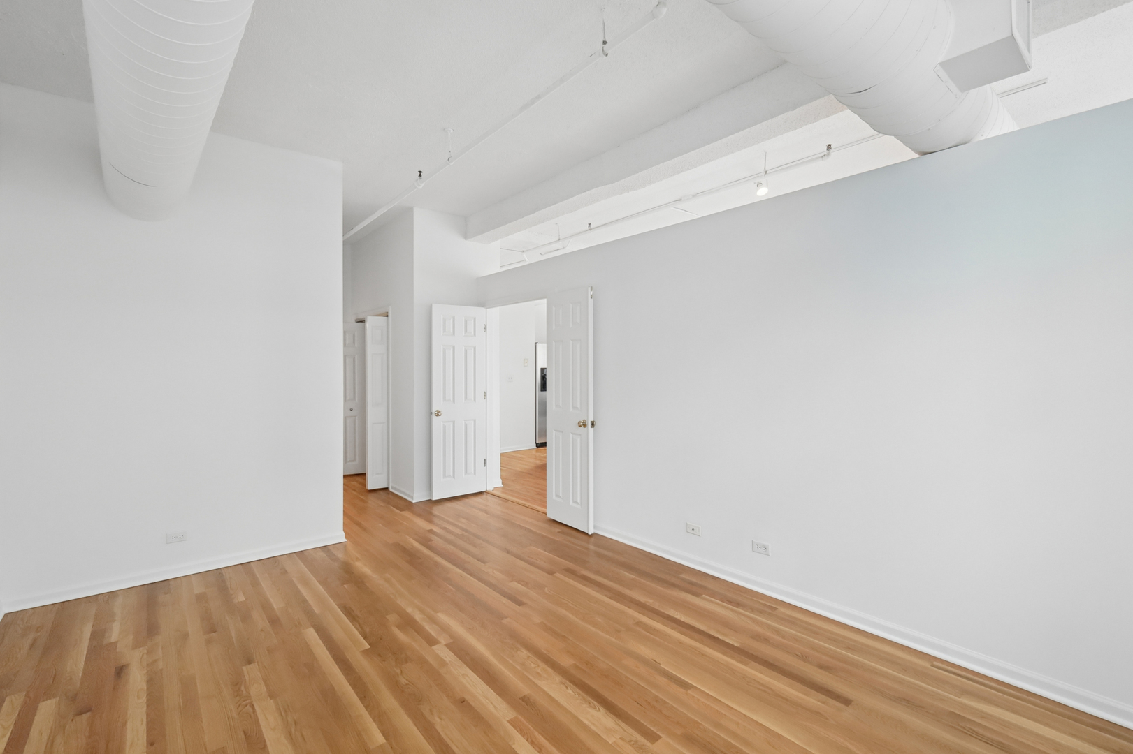 161 West Harrison Street, Unit 1007 Chicago, IL 60605 - Photo 18 of 35 a view of a room with wooden floor