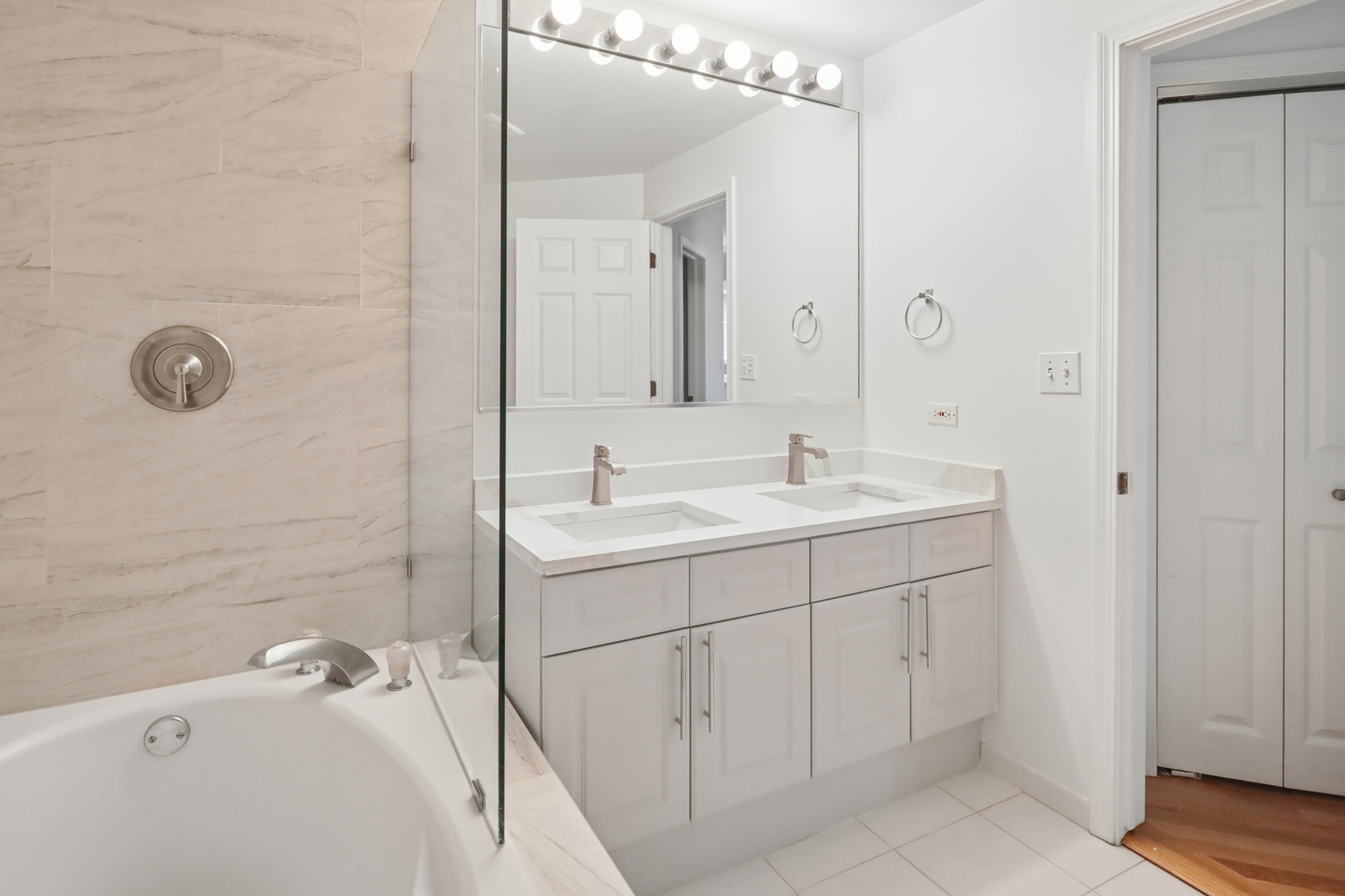 161 West Harrison Street, Unit 1007 Chicago, IL 60605 - Photo 22 of 35 a bathroom with a sink and mirror with shower