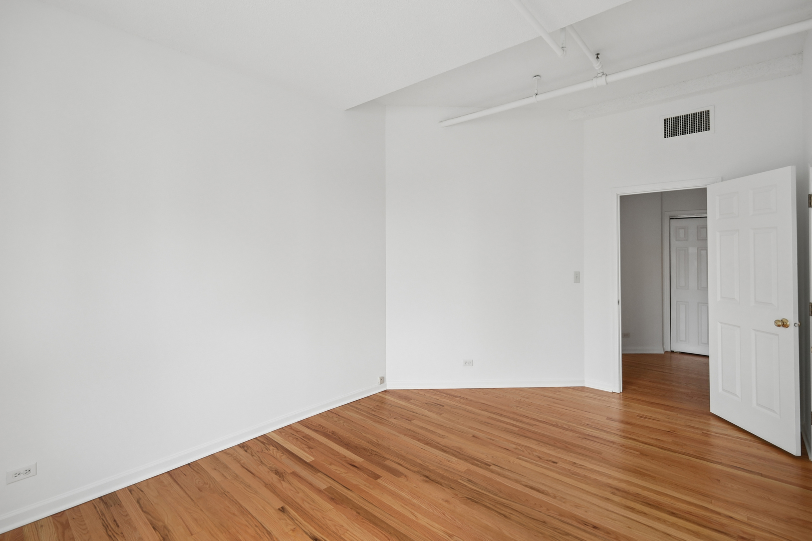 161 West Harrison Street, Unit 1007 Chicago, IL 60605 - Photo 26 of 35 a view of an empty room with wooden floor