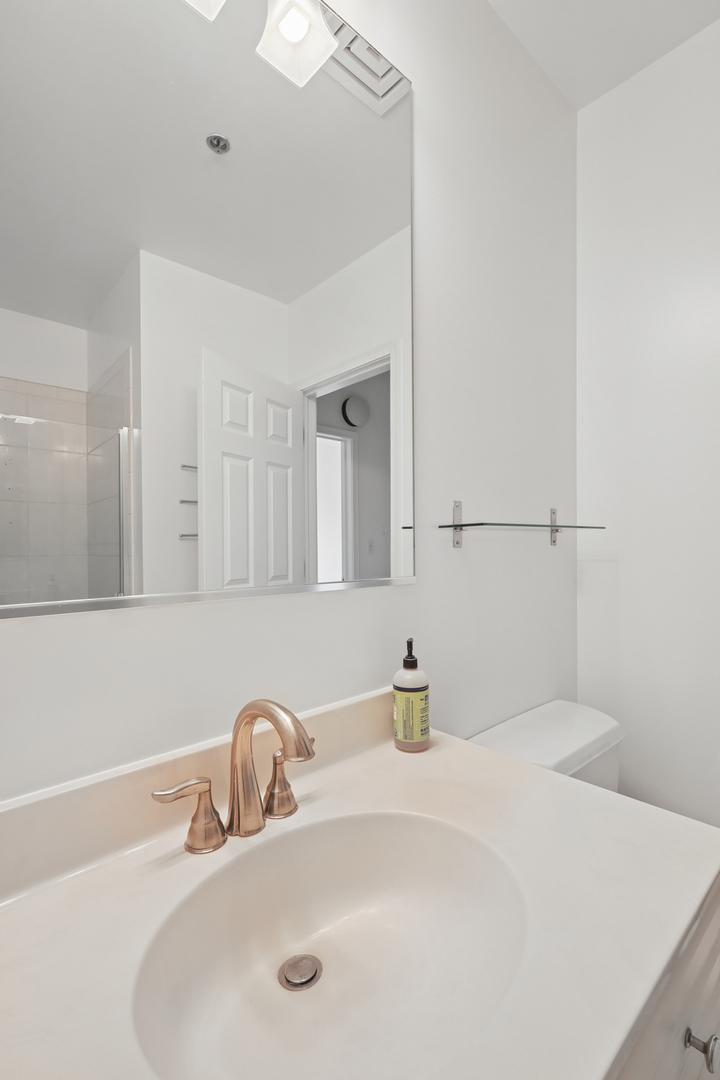 161 West Harrison Street, Unit 1007 Chicago, IL 60605 - Photo 27 of 35 a bathroom with a sink and a mirror