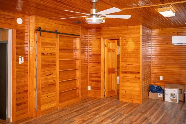 a view of a livingroom with wooden floor and a ceiling fan