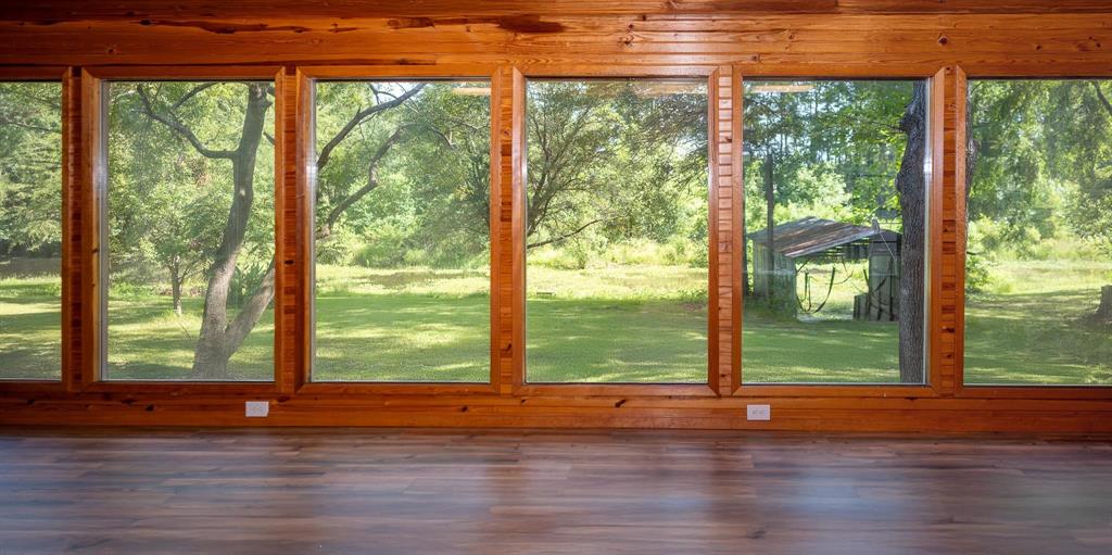 523 Big Lake Road Karnack, TX 75661 - Photo 12 of 27 a view of a room with wooden floor and windows