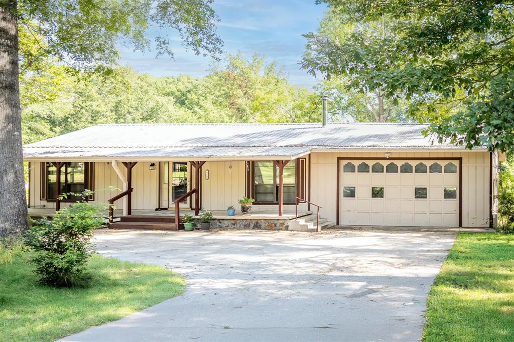 523 Big Lake Road Karnack, TX 75661 - Photo 2 of 27 a front view of a building with garden