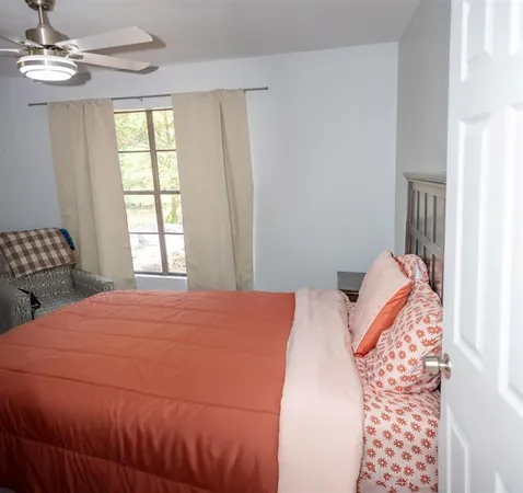 a bedroom with a bed and a window