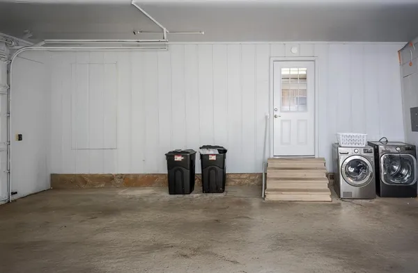 a view of a storage & utility room with a washing machine
