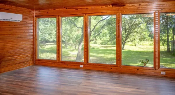 a view of a room with wooden floor and walls
