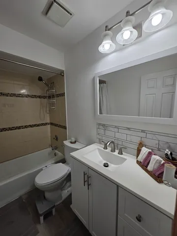 a bathroom with a sink double vanity and tub