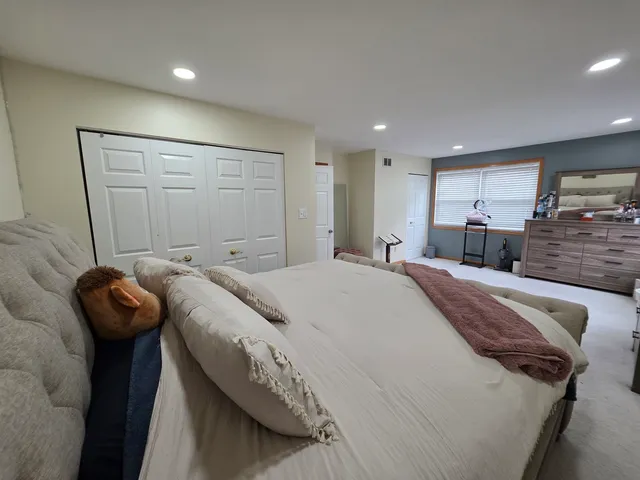 a bed sitting in a room next to a window