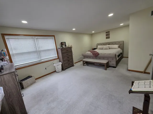 a spacious bedroom with a bed and a window