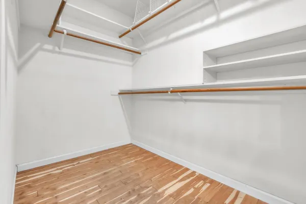 a view of a room with wooden floor and white walls