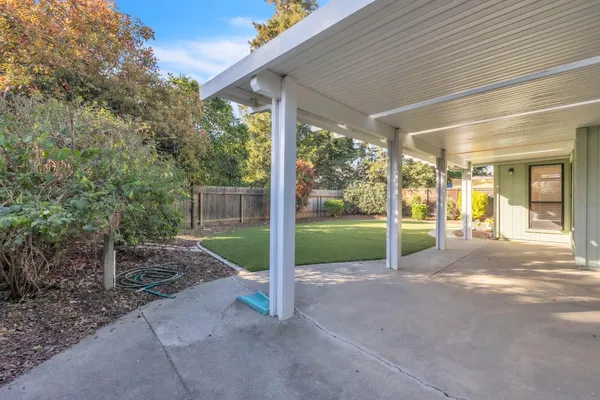 a view of a house with backyard and porch
