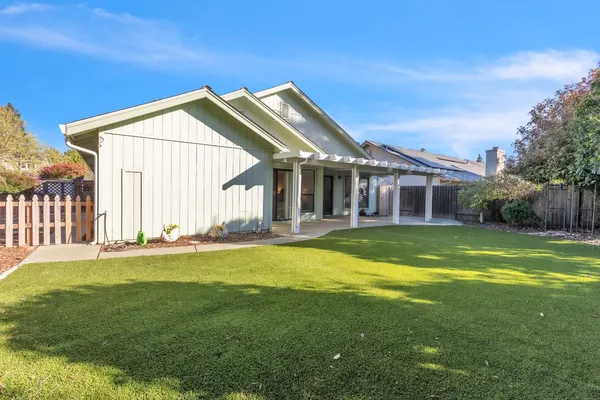 a view of a house with a swimming pool and a yard