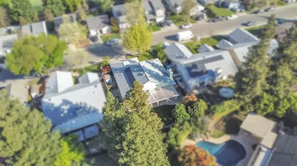 a aerial view of a house with a yard and garden
