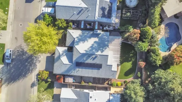 a aerial view of a house with a yard and garden