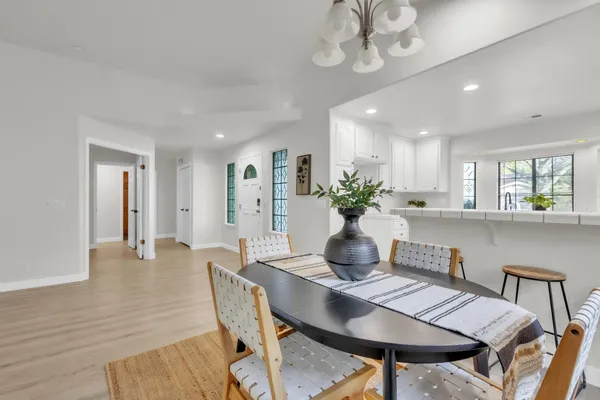 a dining room with furniture and wooden floor