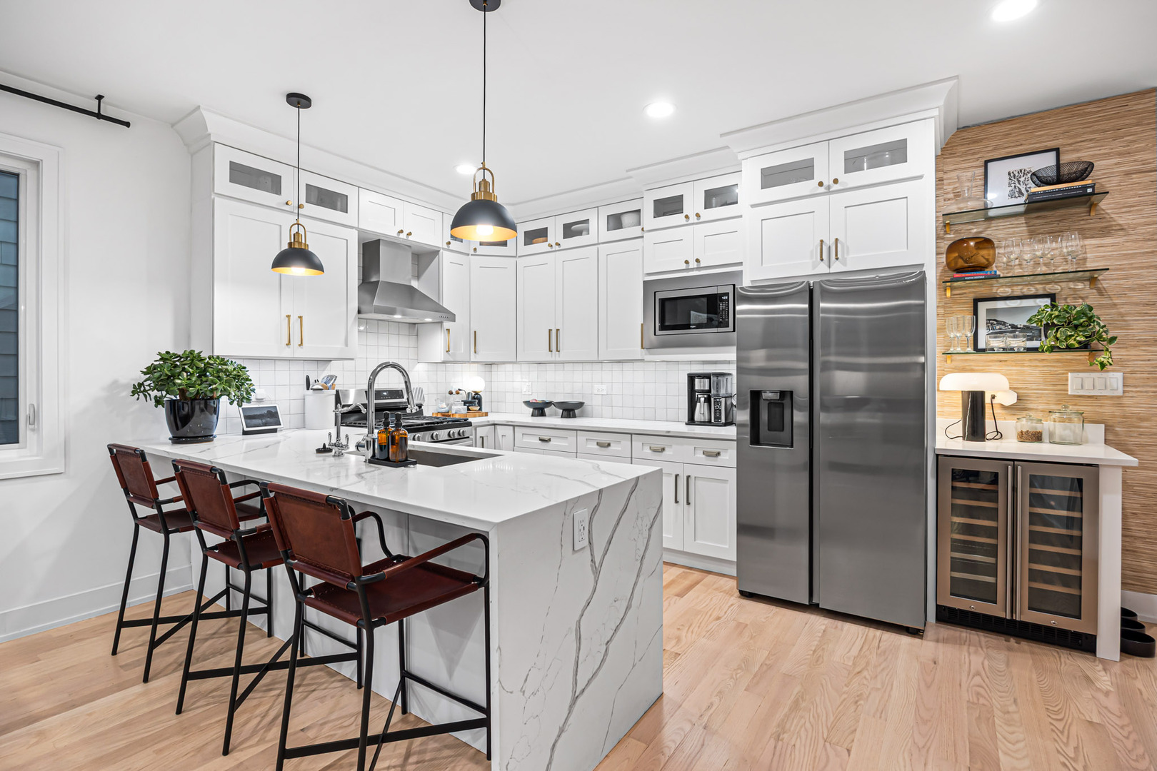 1738 West 17th Street, Unit 3 Chicago, IL 60608 - Photo 5 of 23 a kitchen with stainless steel appliances granite countertop a refrigerator a sink dishwasher a stove a dining table and chairs with wooden floor