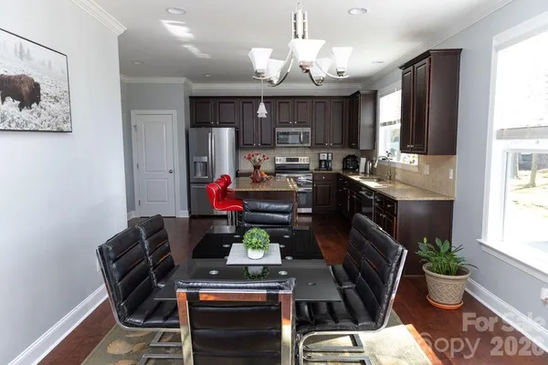 a view of kitchen dining table and chairs