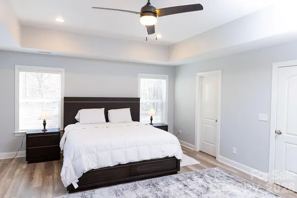 a bedroom with a bed and wooden floor