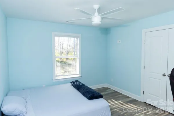 a bedroom with a bed and a window