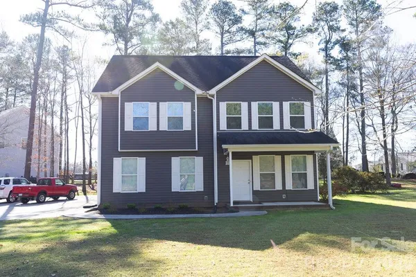 a front view of a house with a yard