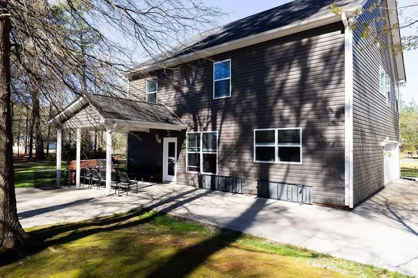 a view of house with swimming pool and porch with furniture