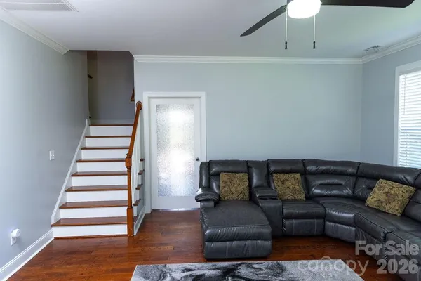 a living room with furniture and a stairs
