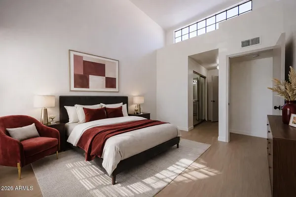 a spacious bedroom with a bed and a couch