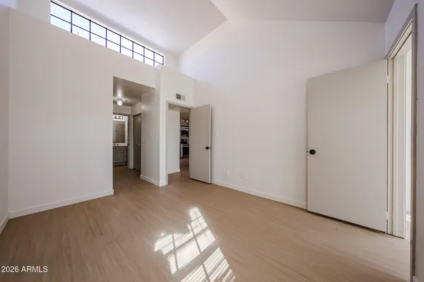 a view of a hallway with wooden floor
