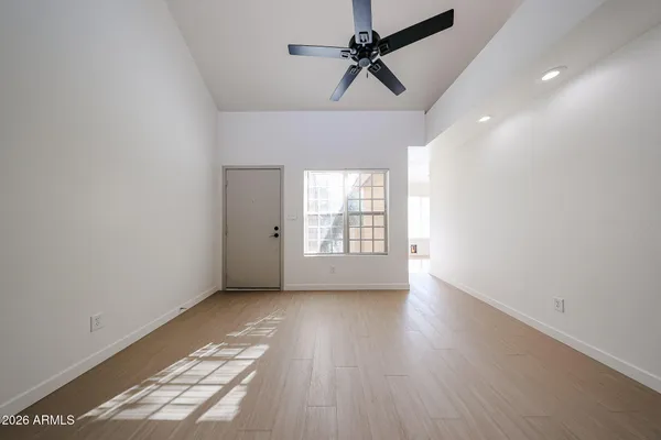 wooden floor in an empty room with a window