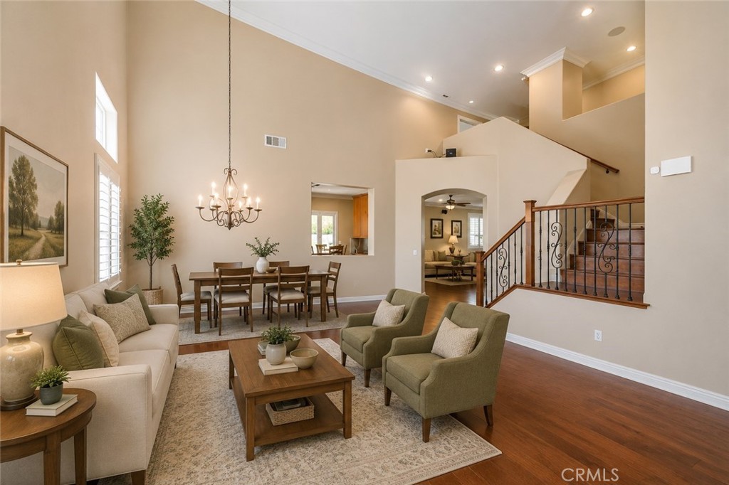 33351 Nicholas Common Temecula, CA 92592 - Photo 8 of 42 a living room with furniture kitchen view and a chandelier