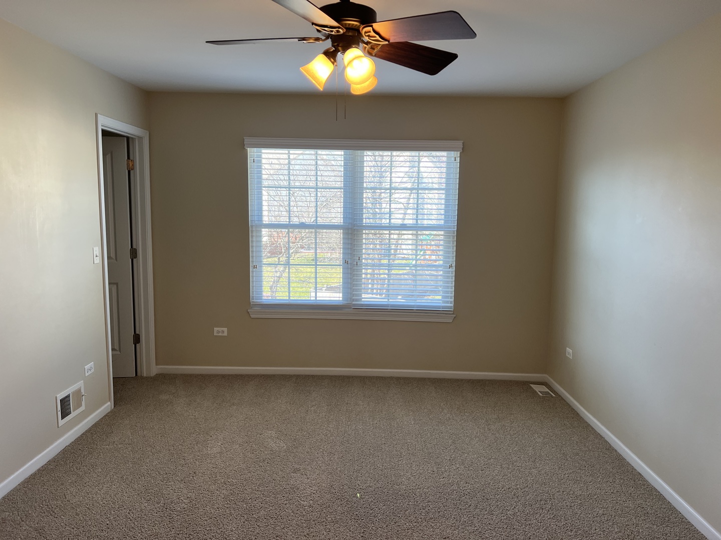 26112 Mapleview Drive Plainfield, IL 60585 - Photo 15 of 28 an empty room with a window and a fan