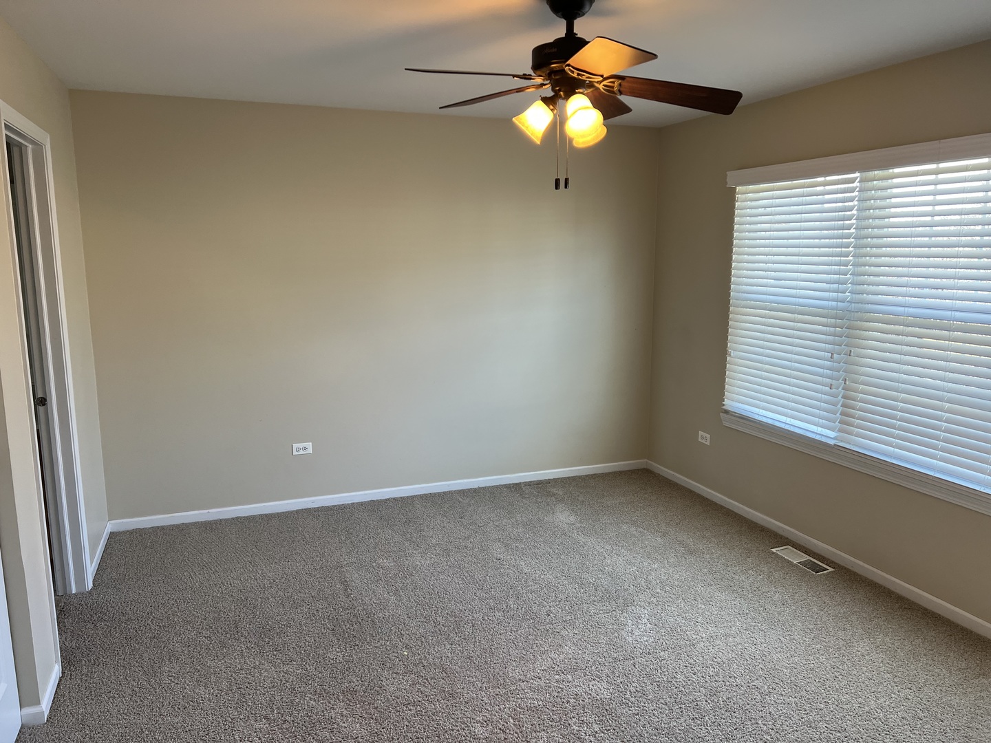 26112 Mapleview Drive Plainfield, IL 60585 - Photo 17 of 28 an empty room with a window and a fan