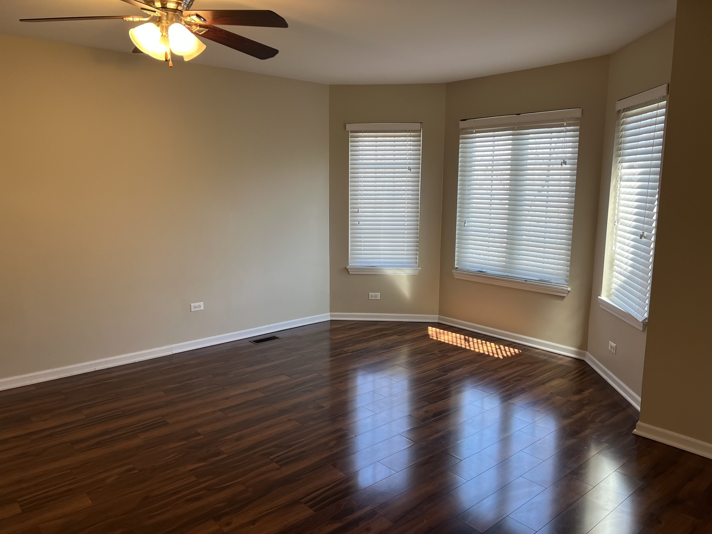 26112 Mapleview Drive Plainfield, IL 60585 - Photo 20 of 28 a view of an empty room with wooden floor and a window