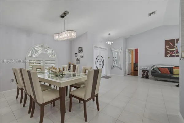 a dining room with furniture and window