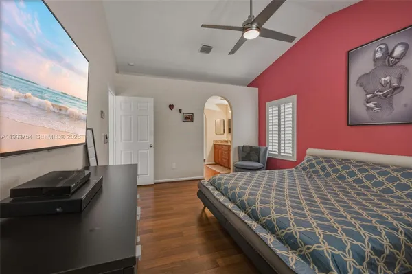 a bedroom with a bed and wooden floor
