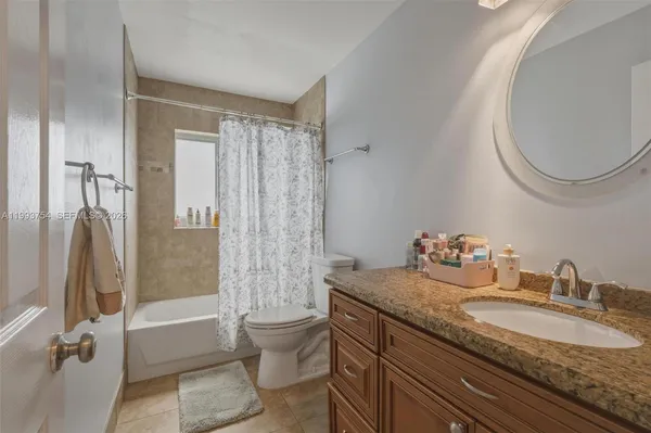 a bathroom with a tub a window and a shower