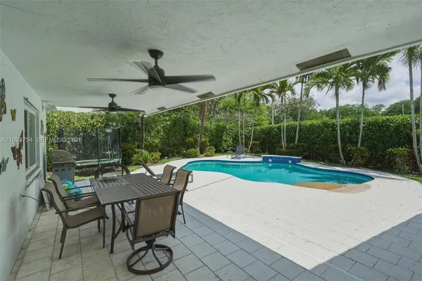 a swimming pool with outdoor seating and yard