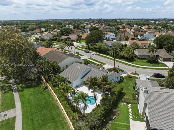 an aerial view of a house with garden space and street view