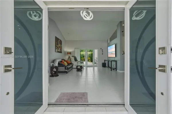 a kitchen with stainless steel appliances a stove a refrigerator and a table