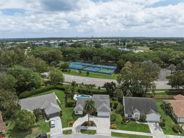 an aerial view of a houses with a yard